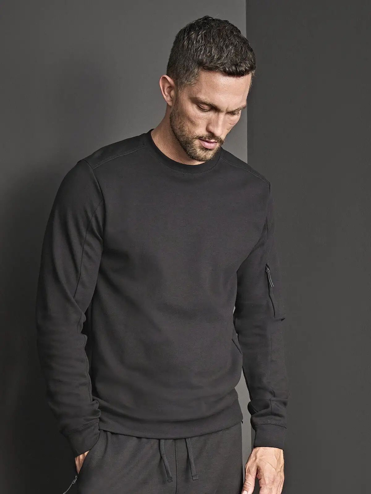 Felpa girocollo interlock con tasca sulla manica con zip e cordoncino - Tee Jays - TJ5700